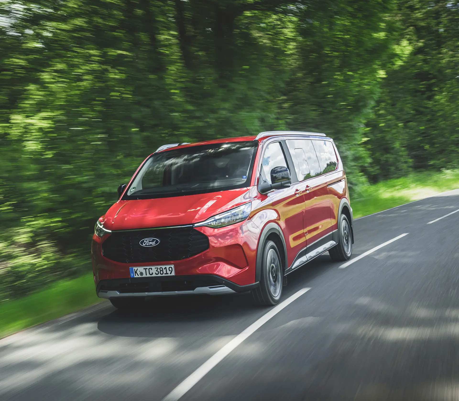 roter Ford Tourneo-Custom fährt auf der Landstraße