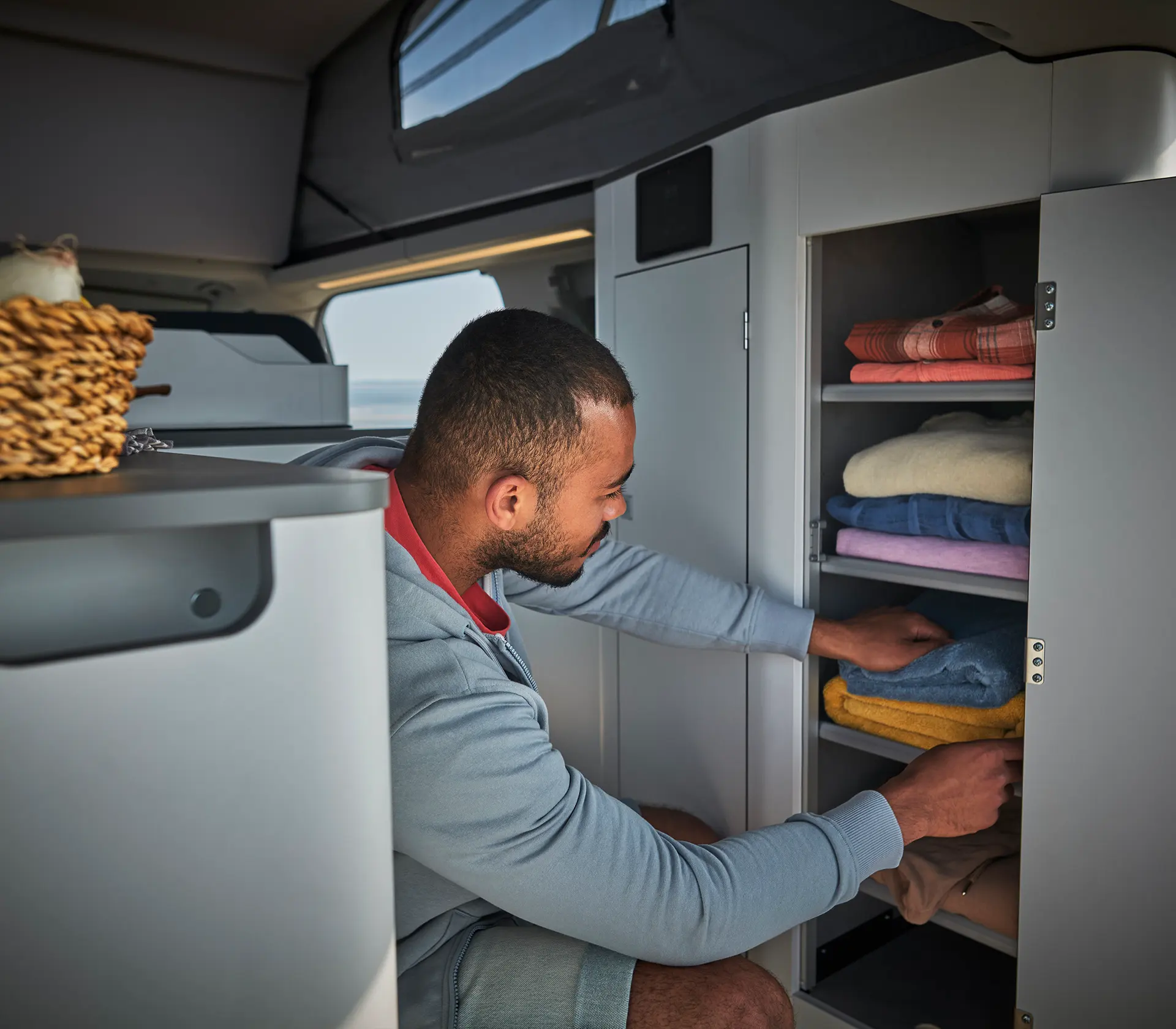 Mann sortiert Kleiderschrank im Ford Nugett