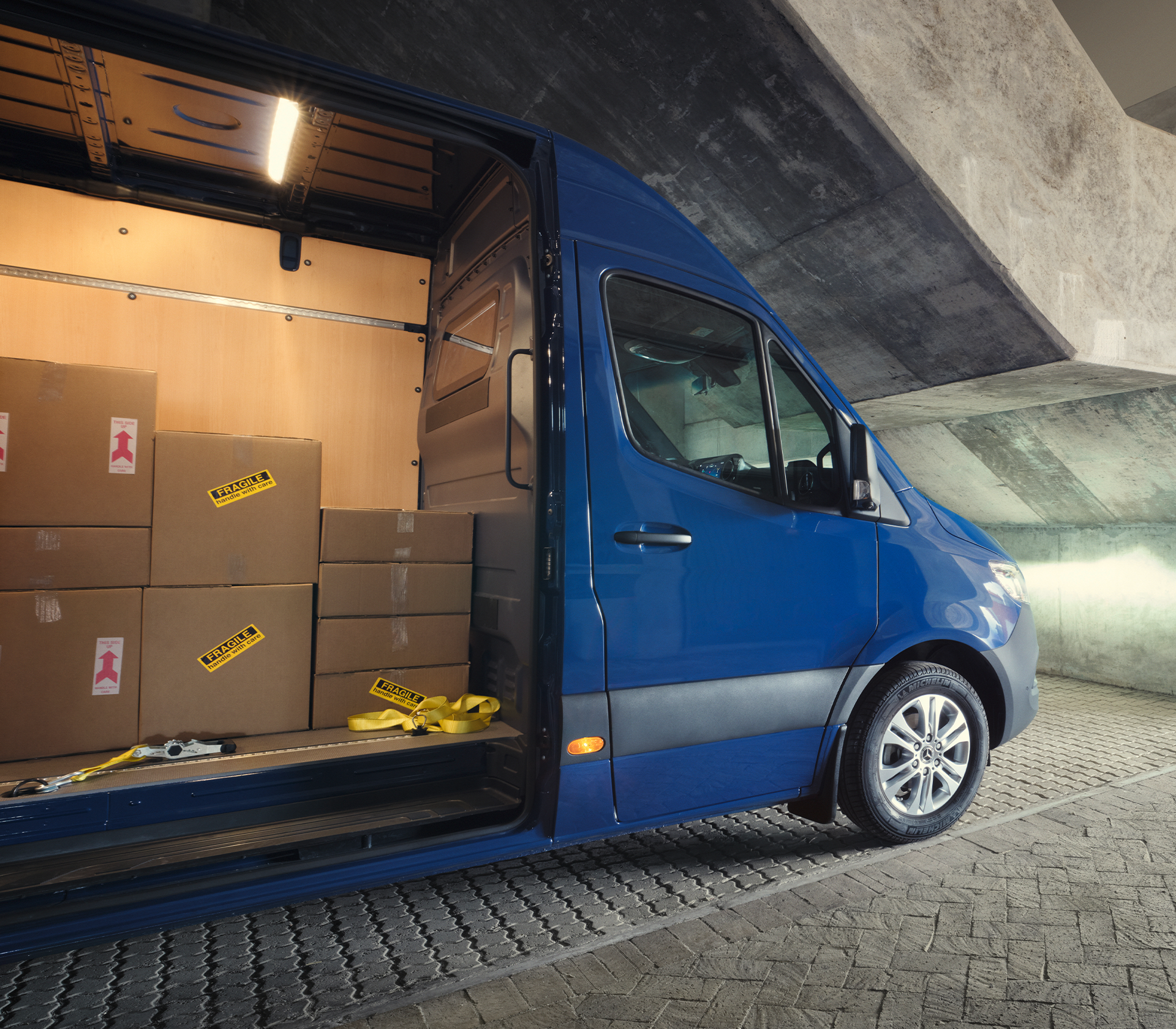 Sprinter Seitenansicht, mit offener Seitentür. Pakte im Sprinter.